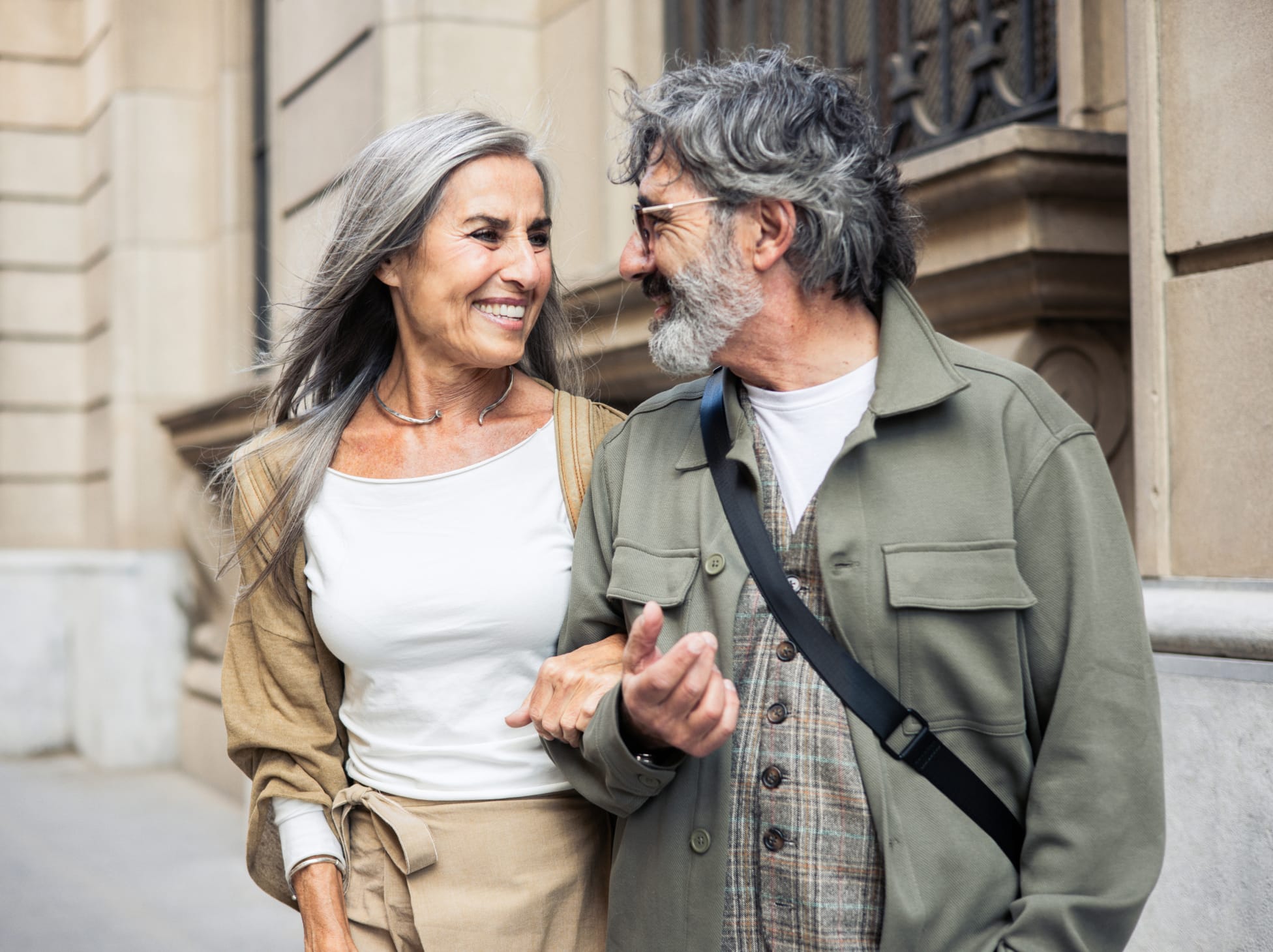 older couple walking with their arms interlinked